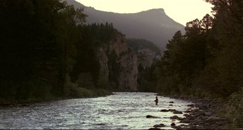Movie still from “A River Runs Through It” (1992), directed by Robert Redford – A man standing in the middle of a river; Extreme Wide shot, High angle