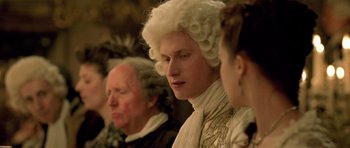 Movie still from “A Royal Affair” (2012), directed by Nikolaj Arcel – A man in a white wig is looking to his left; Close Up shot, Over the shoulder angle