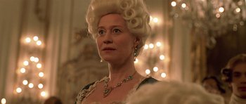 Movie still from “A Royal Affair” (2012), directed by Nikolaj Arcel – A person wearing a dress and a wig; Close Up shot, Low angle