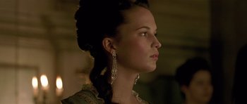 Movie still from “A Royal Affair” (2012), directed by Nikolaj Arcel – A beautiful woman with long black hair wearing a dress; Close Up shot, Low angle