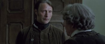 Movie still from “A Royal Affair” (2012), directed by Nikolaj Arcel – Mads mikkelsen as hannibal lecter in a scene from the tv series hannibal; Close Up shot, Over the shoulder angle