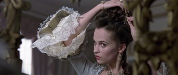 Movie still from “A Royal Affair” (2012), directed by Nikolaj Arcel – A young woman in a victorian era dress; Close Up shot, Over the shoulder angle
