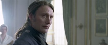 Movie still from “A Royal Affair” (2012), directed by Nikolaj Arcel – A person wearing a suit; Close Up shot, Over the shoulder angle