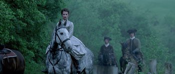 Movie still from “A Royal Affair” (2012), directed by Nikolaj Arcel – A woman riding on the back of a white horse; Medium shot, Over the shoulder angle