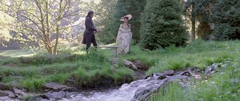 Movie still from “A Royal Affair” (2012), directed by Nikolaj Arcel – A man and a woman standing next to each other in the woods; Wide shot, High angle