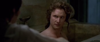 Movie still from “A Royal Affair” (2012), directed by Nikolaj Arcel – A person with long curly hair; Close Up shot, Over the shoulder angle