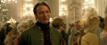 Movie still from “A Royal Affair” (2012), directed by Nikolaj Arcel – A man wearing a green jacket and a black tie; Close Up shot, Over the shoulder angle