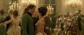 Movie still from “A Royal Affair” (2012), directed by Nikolaj Arcel – A man and a woman standing next to each other; Medium shot, Over the shoulder angle
