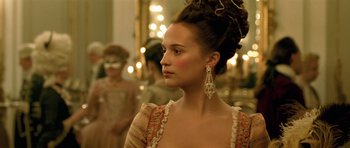 Movie still from “A Royal Affair” (2012), directed by Nikolaj Arcel – A young woman with long brown hair wearing a dress; Close Up shot, Over the shoulder angle