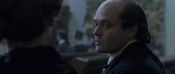Movie still from “A Royal Affair” (2012), directed by Nikolaj Arcel – A man with a bald head is looking into the distance; Close Up shot, Over the shoulder angle