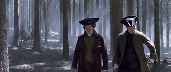 Movie still from “A Royal Affair” (2012), directed by Nikolaj Arcel – A man in a brown coat wearing a hat; Medium shot, Low angle