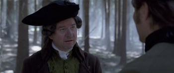Movie still from “A Royal Affair” (2012), directed by Nikolaj Arcel – A man wearing a hat in the woods; Close Up shot, Over the shoulder angle