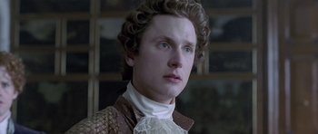 Movie still from “A Royal Affair” (2012), directed by Nikolaj Arcel – A young man in a victorian era outfit; Close Up shot, Low angle