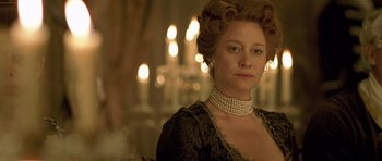 Movie still from “A Royal Affair” (2012), directed by Nikolaj Arcel – A person wearing a dress; Close Up shot, Over the shoulder angle