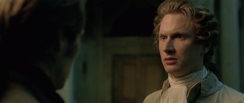 Movie still from “A Royal Affair” (2012), directed by Nikolaj Arcel – A man standing next to another man in front of a building; Close Up shot, Over the shoulder angle