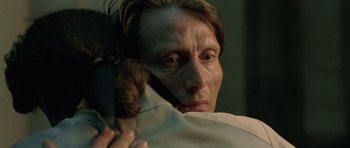 Movie still from “A Royal Affair” (2012), directed by Nikolaj Arcel – A person holding a cat on his shoulder; Close Up shot, Over the shoulder angle