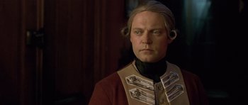 Movie still from “A Royal Affair” (2012), directed by Nikolaj Arcel – A person wearing a costume; Close Up shot, Over the shoulder angle