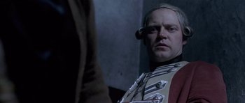 Movie still from “A Royal Affair” (2012), directed by Nikolaj Arcel – A man in a uniform looking at the camera; Close Up shot, Low angle