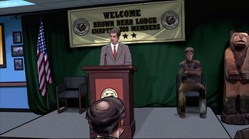 Movie still from “A Scanner Darkly” (2006), directed by Richard Linklater – A man standing at a podium in front of two people; Wide shot, High angle