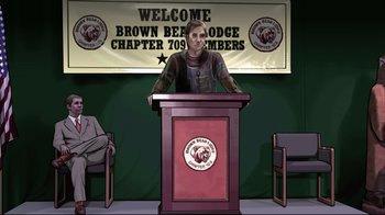 Movie still from “A Scanner Darkly” (2006), directed by Richard Linklater – A man standing at a podium in front of chairs; Wide shot, High angle