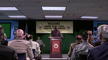 Movie still from “A Scanner Darkly” (2006), directed by Richard Linklater – A man is speaking at a podium in front of a group of people; Wide shot, High angle