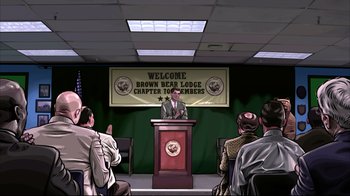 Movie still from “A Scanner Darkly” (2006), directed by Richard Linklater – A man is giving a speech to a group of people; Wide shot, High angle