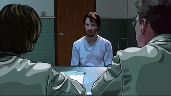 Movie still from “A Scanner Darkly” (2006), directed by Richard Linklater – A man sitting at a table in front of a laptop; Medium shot, Over the shoulder angle