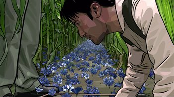 Movie still from “A Scanner Darkly” (2006), directed by Richard Linklater – A man looking at a field of blue flowers; Extreme Close Up shot, Overhead angle