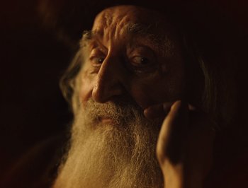 Movie still from “A Serious Man” (2009), directed by Joel Coen – An old man with a long white beard; Close Up shot, Over the shoulder angle