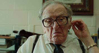 Movie still from “A Serious Man” (2009), directed by Joel Coen – An older man wearing glasses and a tie; Close Up shot, Low angle