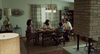 Movie still from “A Serious Man” (2009), directed by Joel Coen – A group of people sitting around a table in a living room; Wide shot, High angle