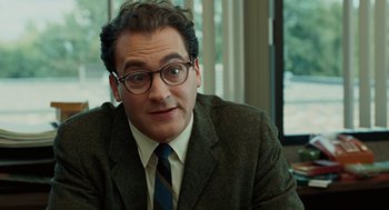 Movie still from “A Serious Man” (2009), directed by Joel Coen – A person wearing a suit and tie; Close Up shot, Over the shoulder angle