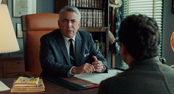 Movie still from “A Serious Man” (2009), directed by Joel Coen – An older man sitting at a table in front of a young man; Medium shot, Over the shoulder angle