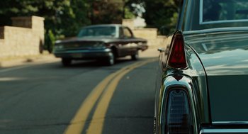 Movie still from “A Serious Man” (2009), directed by Joel Coen – The tail lights of a car; Wide shot, Low angle