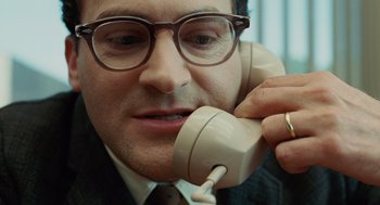 Movie still from “A Serious Man” (2009), directed by Joel Coen – A person talking on a phone; Close Up shot, High angle