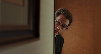 Movie still from “A Serious Man” (2009), directed by Joel Coen – A man looking at himself in a mirror; Close Up shot, Over the shoulder angle