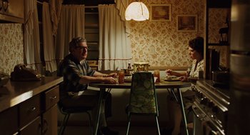 Movie still from “A Serious Man” (2009), directed by Joel Coen – Two people sitting at a table eating food; Wide shot, High angle