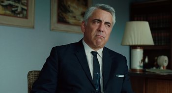 Movie still from “A Serious Man” (2009), directed by Joel Coen – A person wearing a suit and tie; Close Up shot, Over the shoulder angle