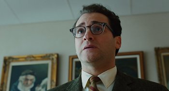 Movie still from “A Serious Man” (2009), directed by Joel Coen – A person wearing glasses and a suit; Close Up shot, Low angle