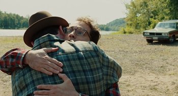 Movie still from “A Serious Man” (2009), directed by Joel Coen – A man and a woman hugging in a field; Close Up shot, Over the shoulder angle