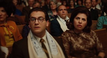 Movie still from “A Serious Man” (2009), directed by Joel Coen – A group of people sitting in a room; Close Up shot, Low angle