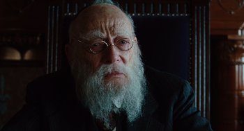Movie still from “A Serious Man” (2009), directed by Joel Coen – An old man with a beard and glasses; Close Up shot, Over the shoulder angle