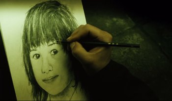 Movie still from “A Short Film About Killing” (1988), directed by Krzysztof Kieslowski – A person is drawing a picture of a woman; Extreme Close Up shot, High angle