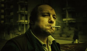 Movie still from “A Short Film About Killing” (1988), directed by Krzysztof Kieslowski – A man with a cigarette in his mouth; Close Up shot, Low angle