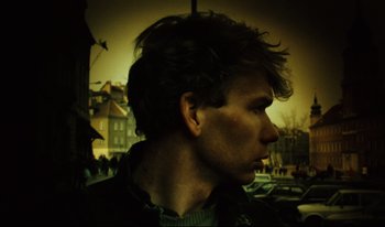 Movie still from “A Short Film About Killing” (1988), directed by Krzysztof Kieslowski – A young man with long dark hair looking to his left; Close Up shot, Low angle
