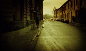 Movie still from “A Short Film About Killing” (1988), directed by Krzysztof Kieslowski – A person walking down a street near a building; Extreme Wide shot, High angle