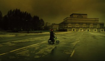 Movie still from “A Short Film About Killing” (1988), directed by Krzysztof Kieslowski – A person riding a bike in a parking lot at night; Extreme Wide shot, High angle