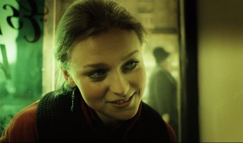 Movie still from “A Short Film About Killing” (1988), directed by Krzysztof Kieslowski – A young woman with green eyes looking at the camera; Close Up shot, Over the shoulder angle