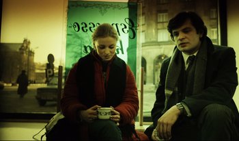 Movie still from “A Short Film About Killing” (1988), directed by Krzysztof Kieslowski – A woman sitting next to a man on a bus; Medium shot, Low angle