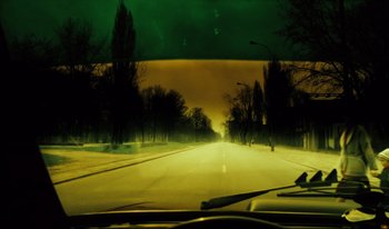 Movie still from “A Short Film About Killing” (1988), directed by Krzysztof Kieslowski – A view from a car of a street at night; Wide shot, High angle